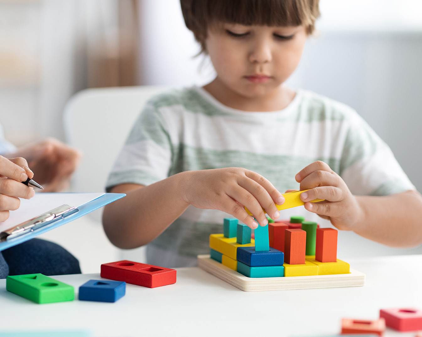 Young child building blocks in play therapy with child therapy